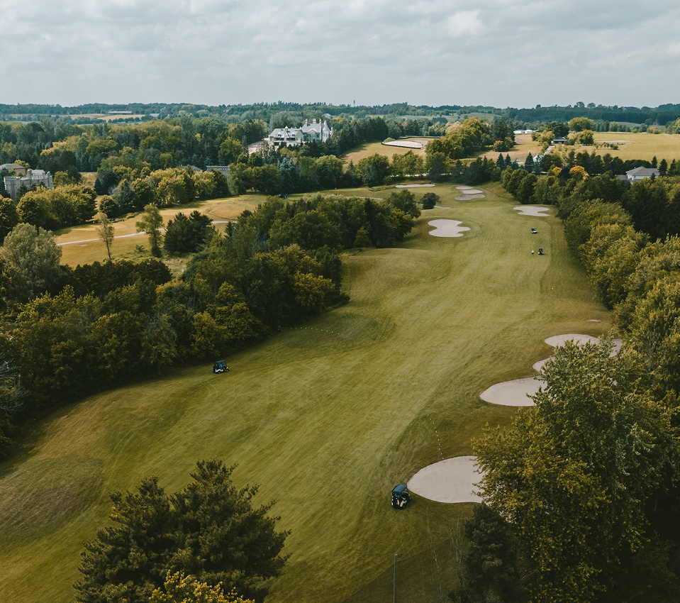 Aerial view of Mayfield Golf Club fairways surrounded by trees